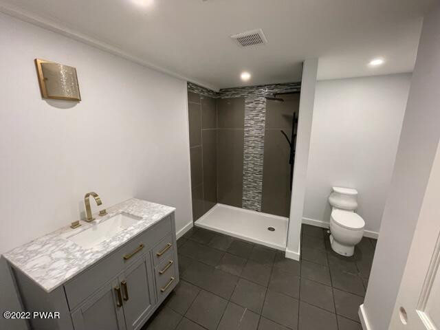 2 Hudson Street Hawley, PA 18428 - Photo 28 of 43 a bathroom with a granite countertop sink a toilet and a mirror