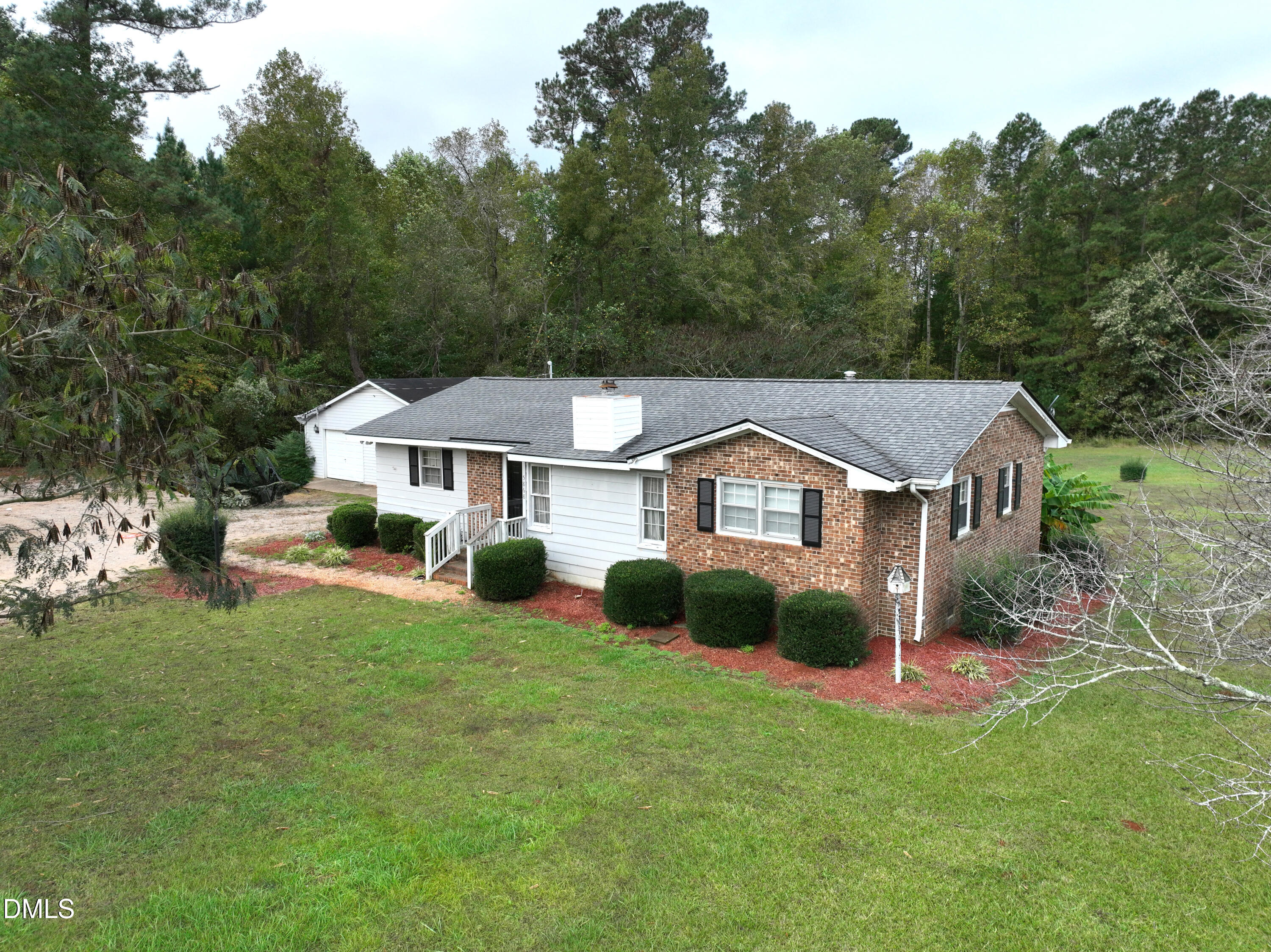 5868 Massey Road Zebulon, NC 27597 - Photo 1 of 24 a aerial view of a house with a big yard and large trees