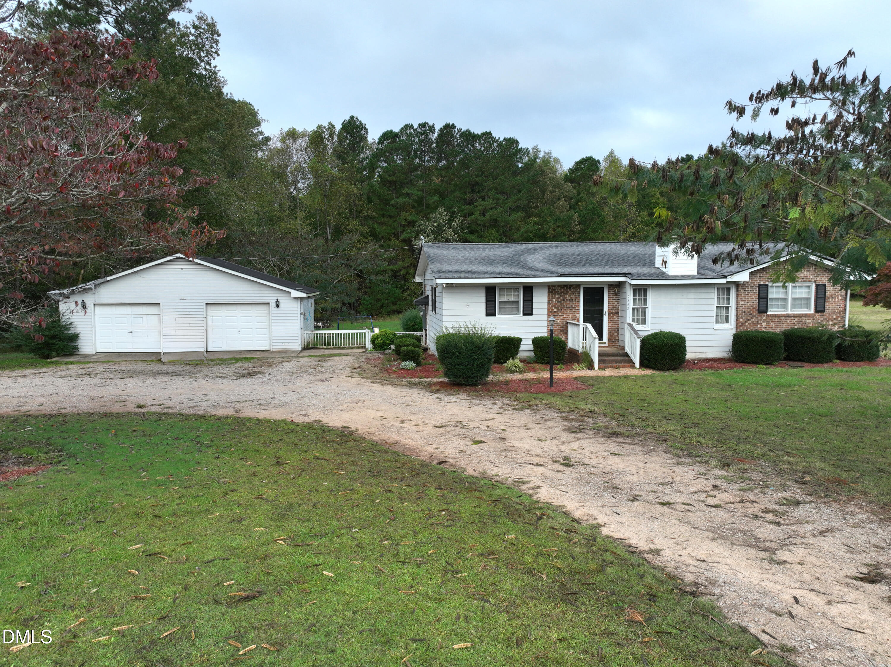 5868 Massey Road Zebulon, NC 27597 - Photo 2 of 24 a front view of a house with a yard and green space