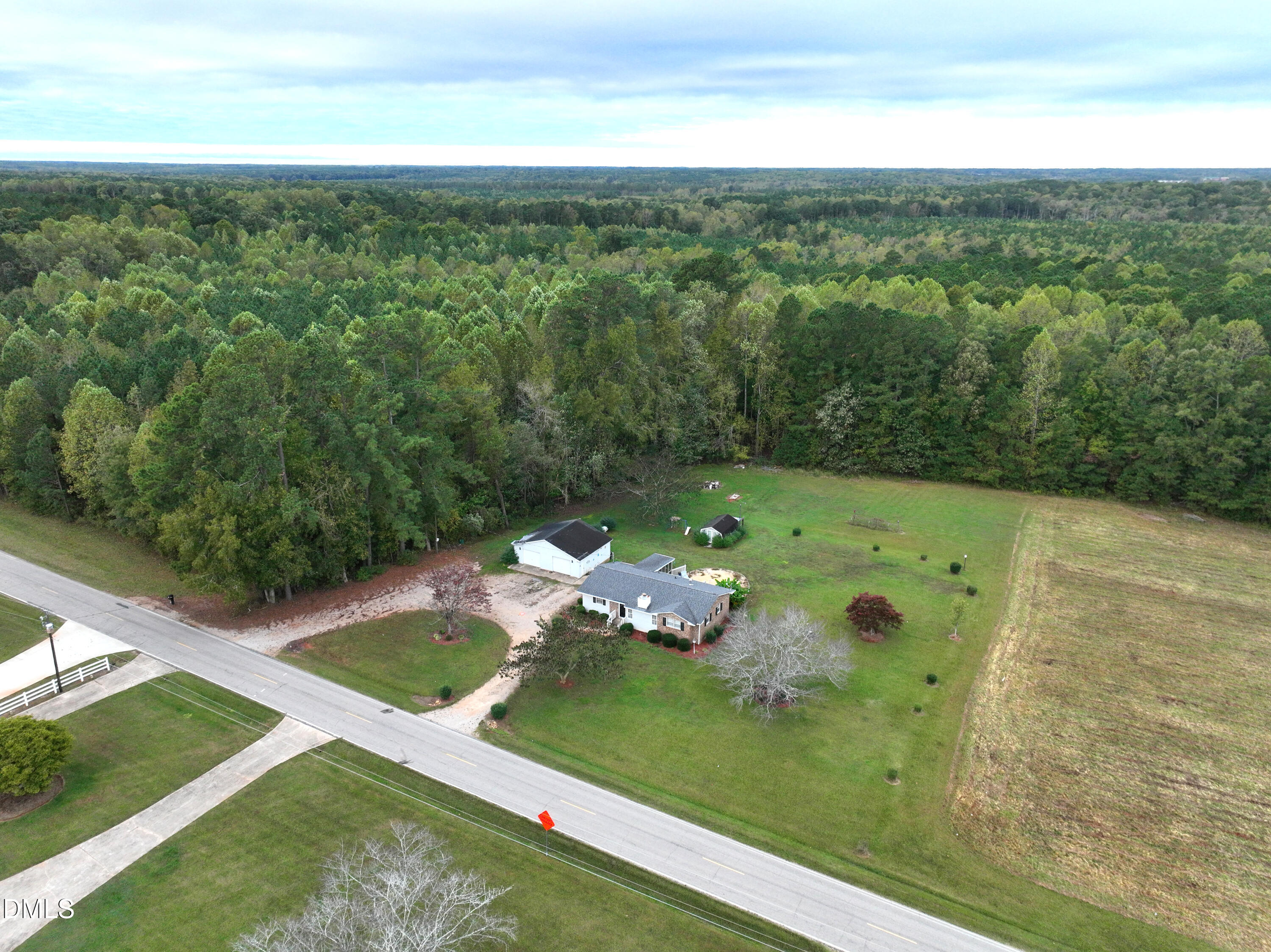 5868 Massey Road Zebulon, NC 27597 - Photo 4 of 24 a view of a big yard with potted plants