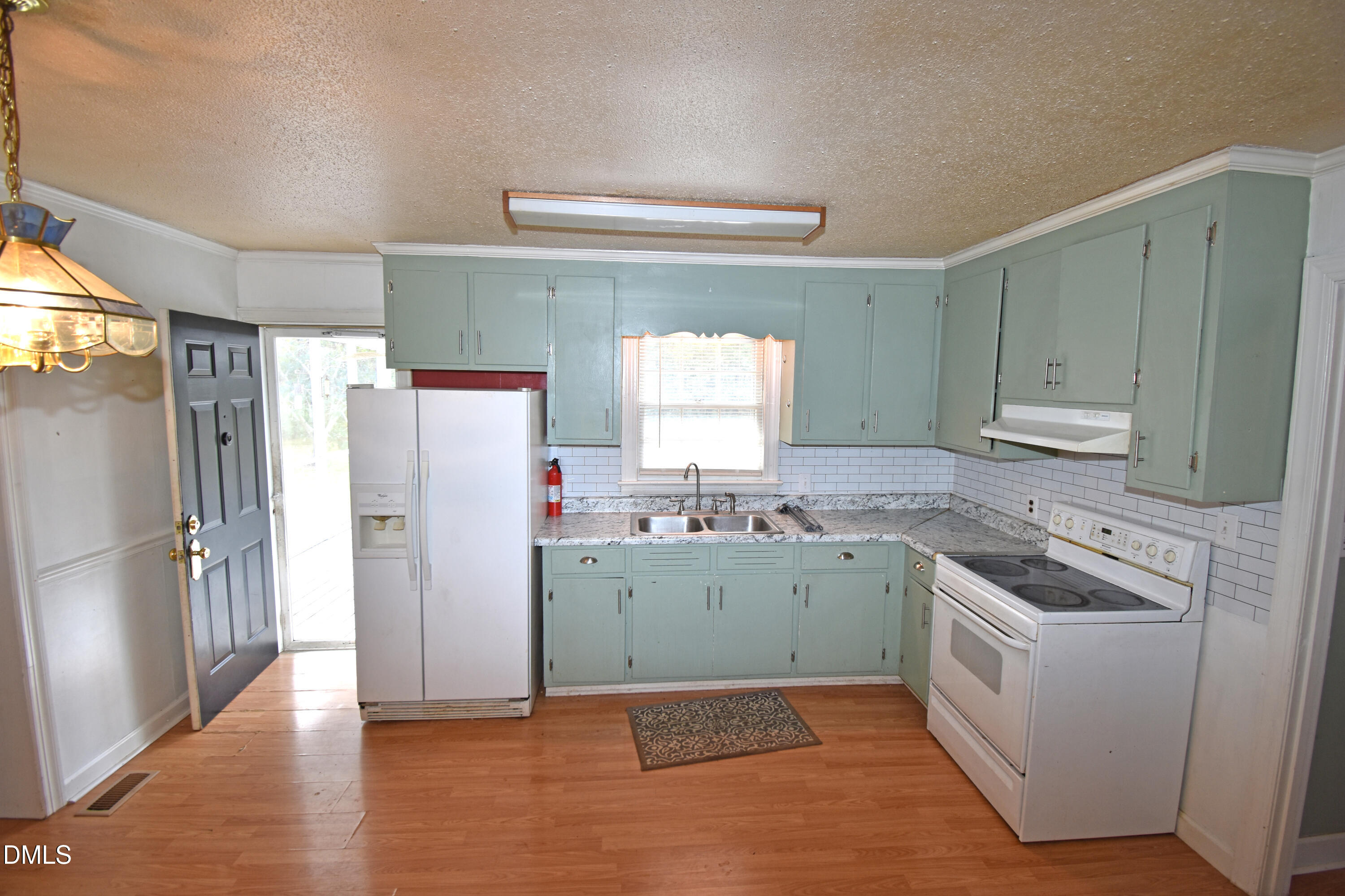 5868 Massey Road Zebulon, NC 27597 - Photo 5 of 24 a kitchen with a refrigerator stove and sink