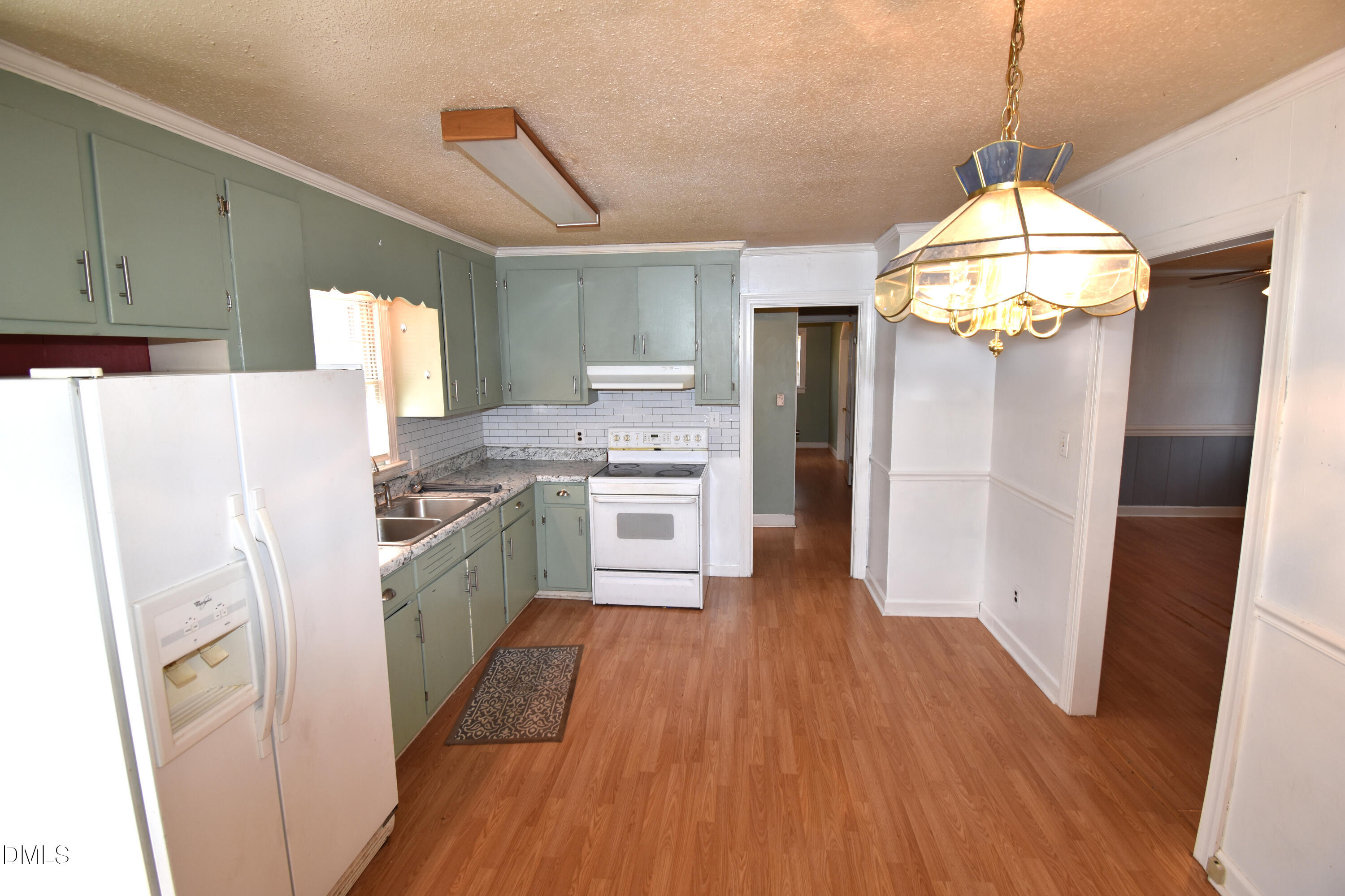 5868 Massey Road Zebulon, NC 27597 - Photo 6 of 24 a kitchen with stainless steel appliances a stove a refrigerator and a wooden floor