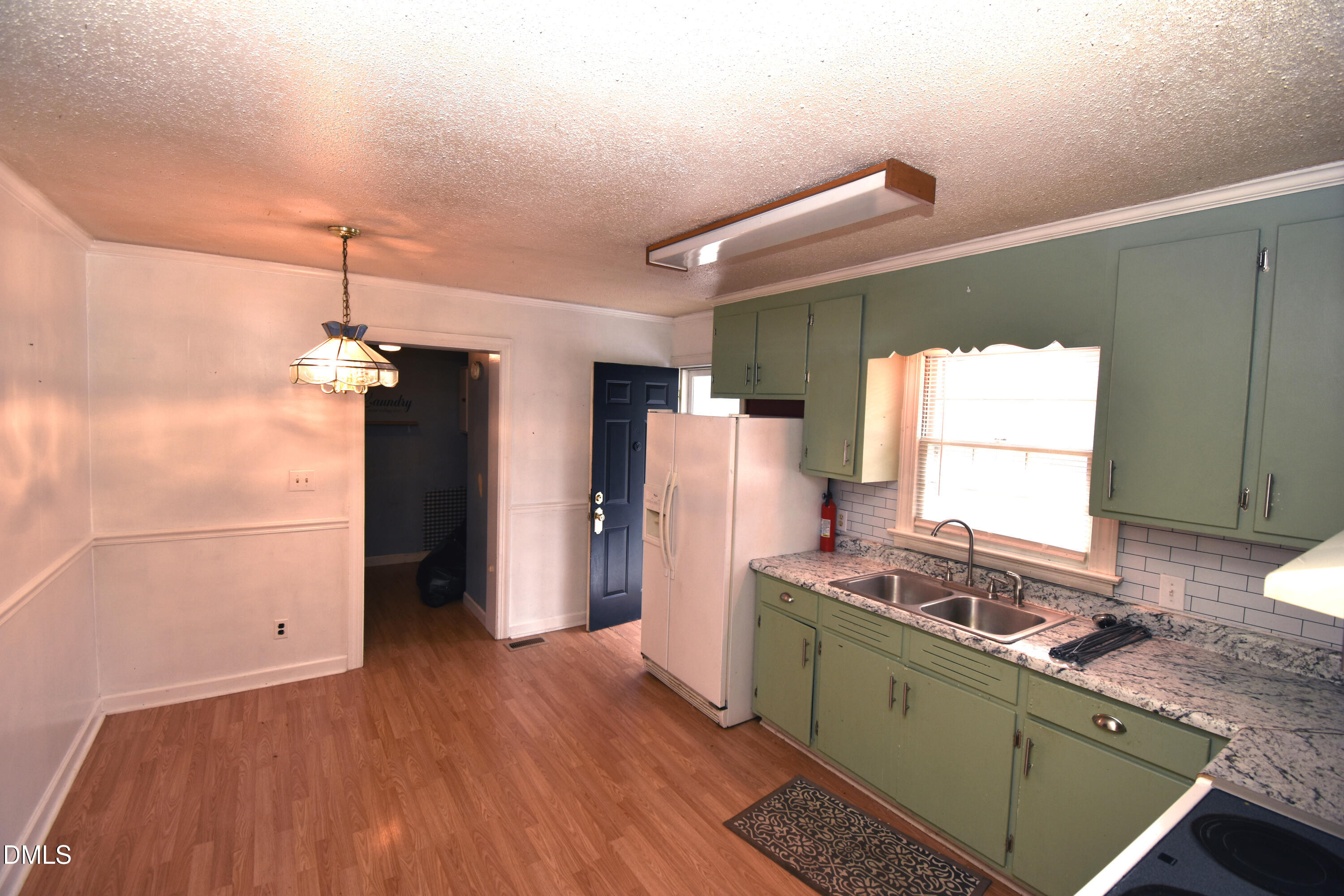 5868 Massey Road Zebulon, NC 27597 - Photo 7 of 24 a kitchen with a sink a refrigerator and window