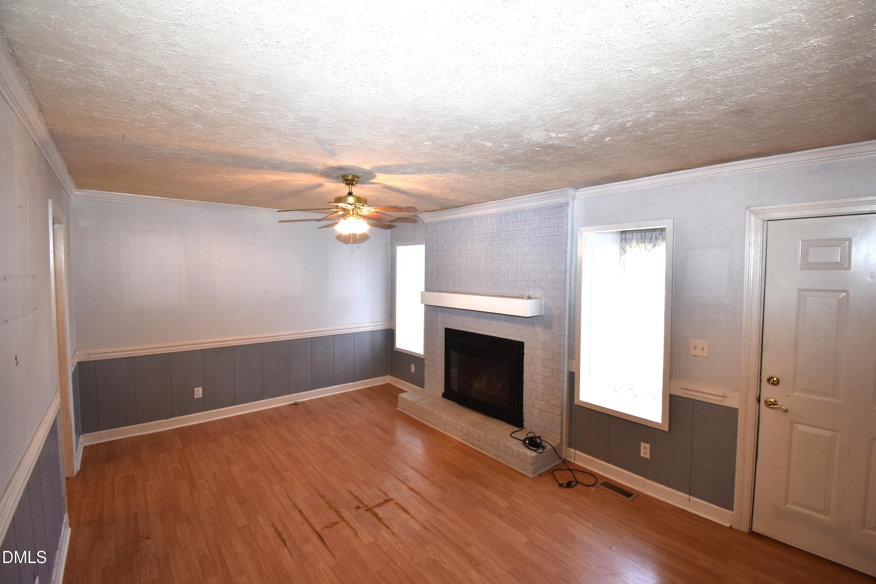 5868 Massey Road Zebulon, NC 27597 - Photo 8 of 24 wooden floor in an empty room with a fireplace