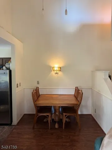 a dining room with furniture and wooden floor