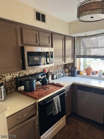 a kitchen with a sink a stove and cabinets