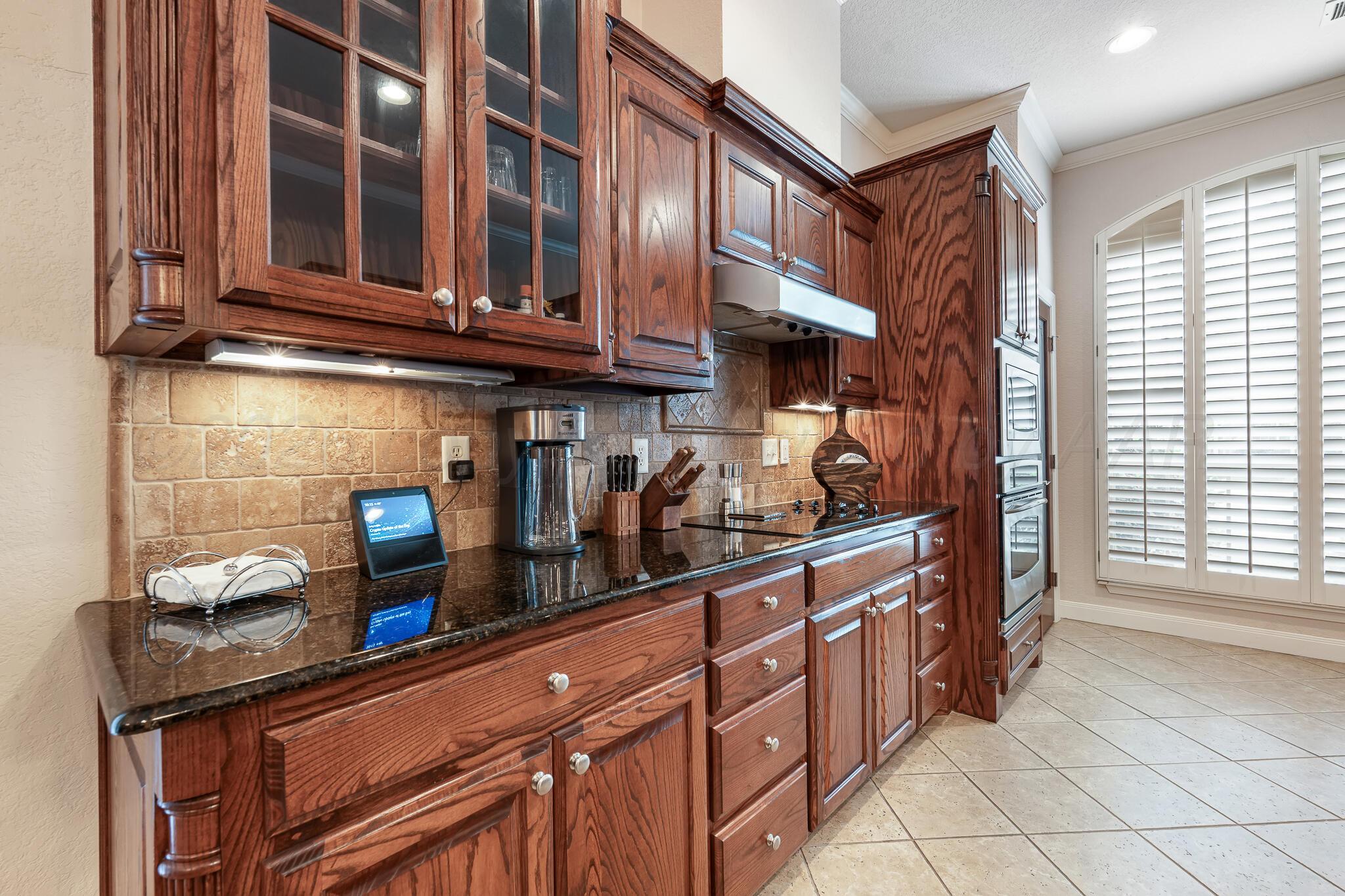 5008 Wesley Road Amarillo, TX 79119 - Photo 11 of 47 a kitchen with stainless steel appliances granite countertop a sink and cabinets