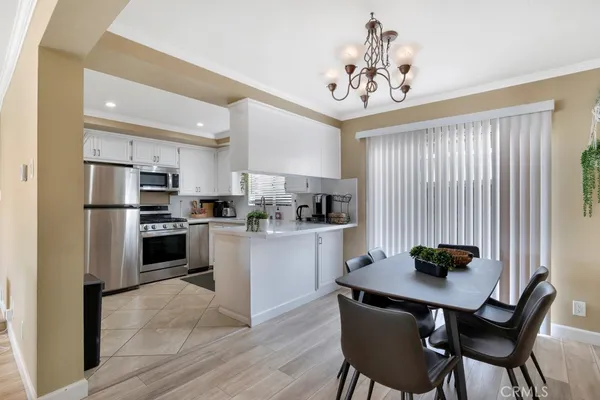 a kitchen with a refrigerator a stove a sink dishwasher and a refrigerator with wooden floor