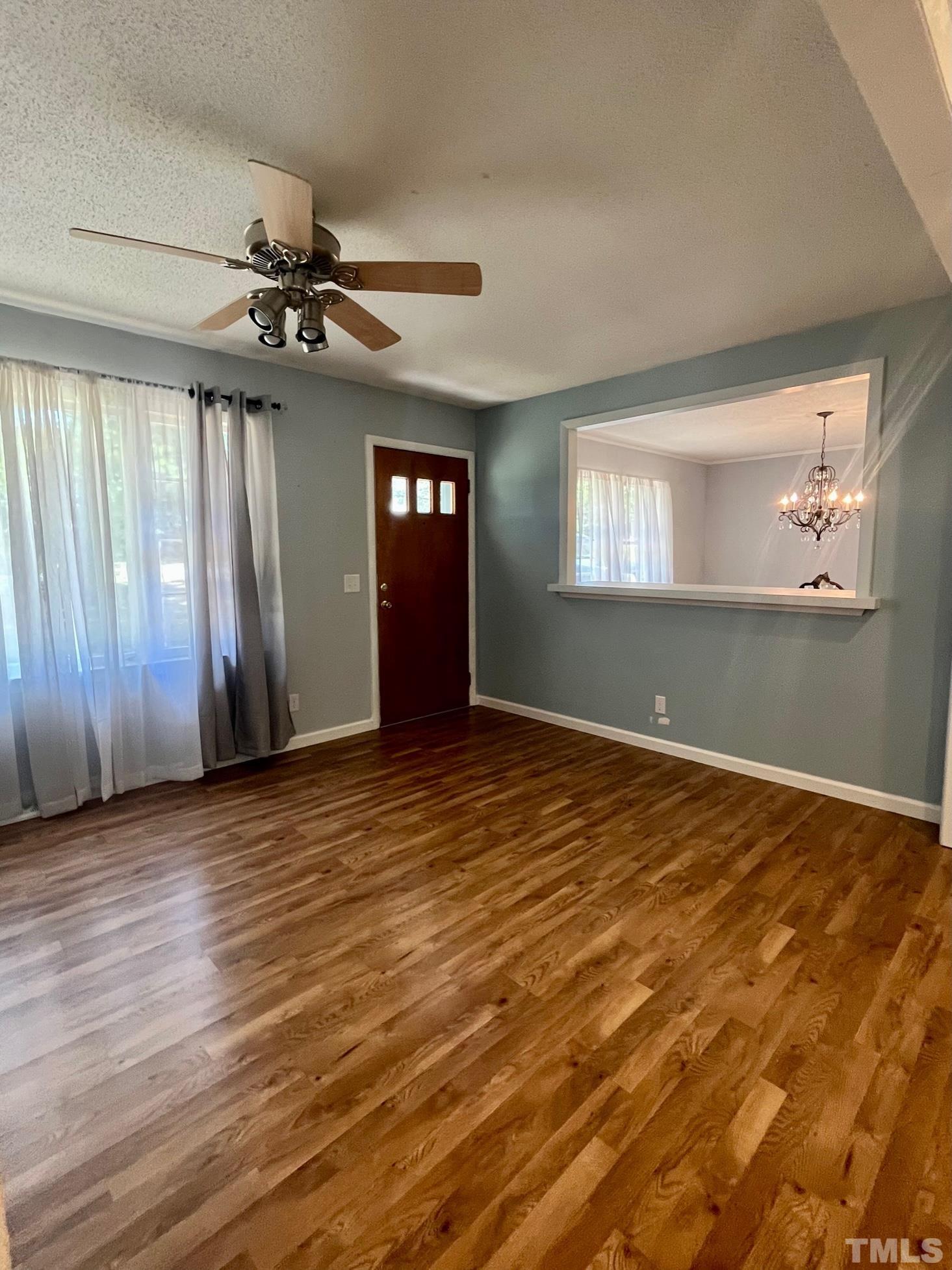 2342 Mitchell Road Angier, NC 27501 - Photo 8 of 10 an empty room with wooden floor fan and windows
