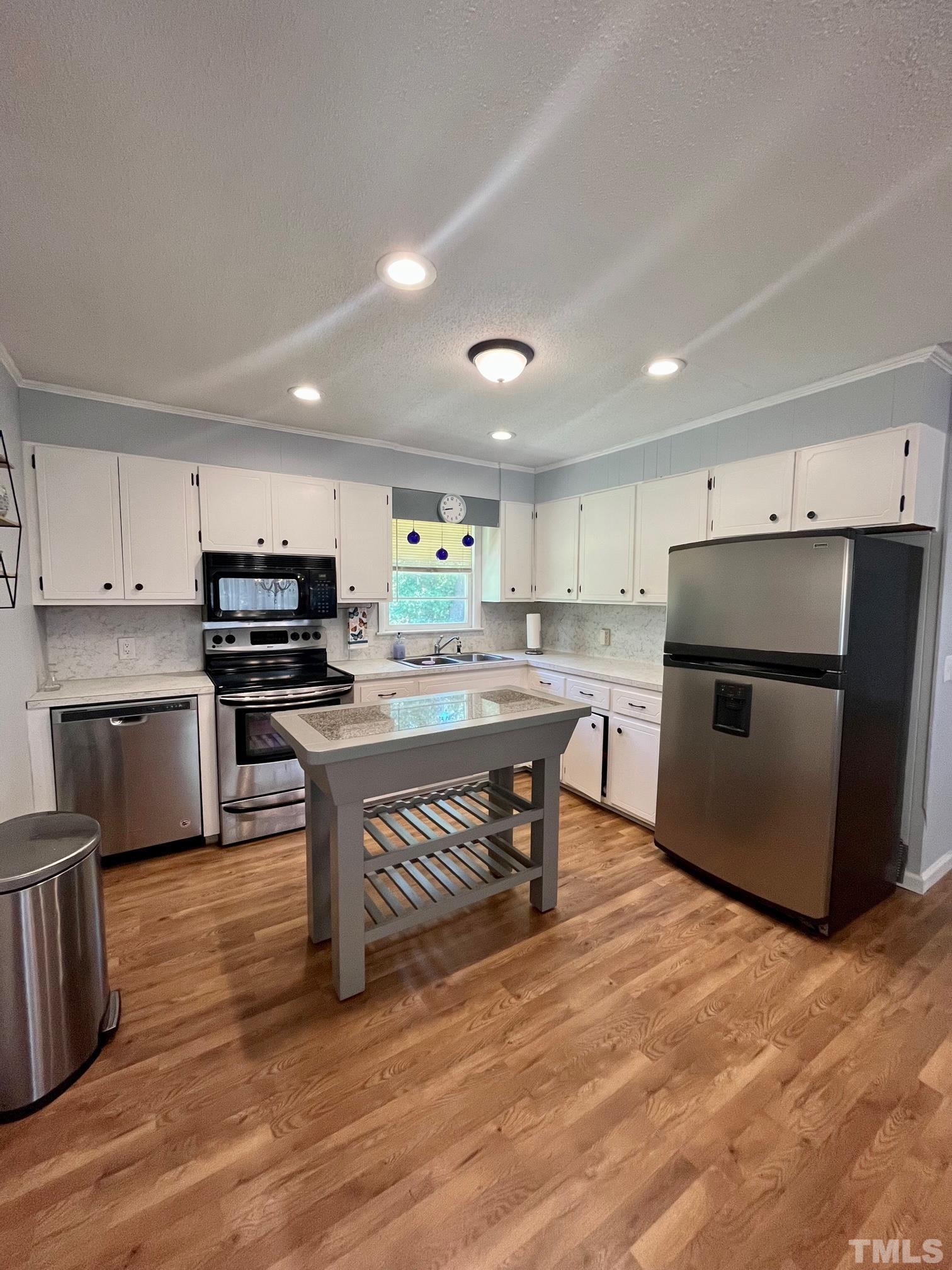 2342 Mitchell Road Angier, NC 27501 - Photo 10 of 10 a kitchen with stainless steel appliances a stove a sink a microwave a refrigerator and cabinets