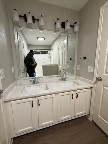 a bathroom with a double vanity sink and a mirror