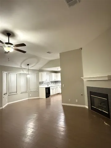 a view of a livingroom with a fireplace and window