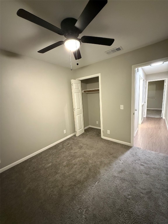 5412 Mesquite Grove Road Austin, TX 78744 - Photo 5 of 15 an empty room with ceiling fan and windows