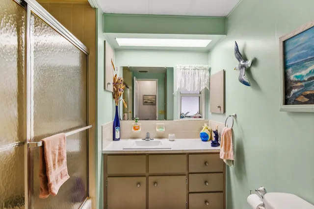a bathroom with a sink vanity and mirror