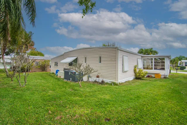 a view of a house with a yard and sitting area