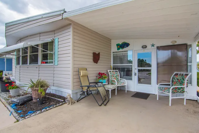a view of a house with backyard and sitting area