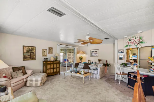 a living room with furniture kitchen and a window