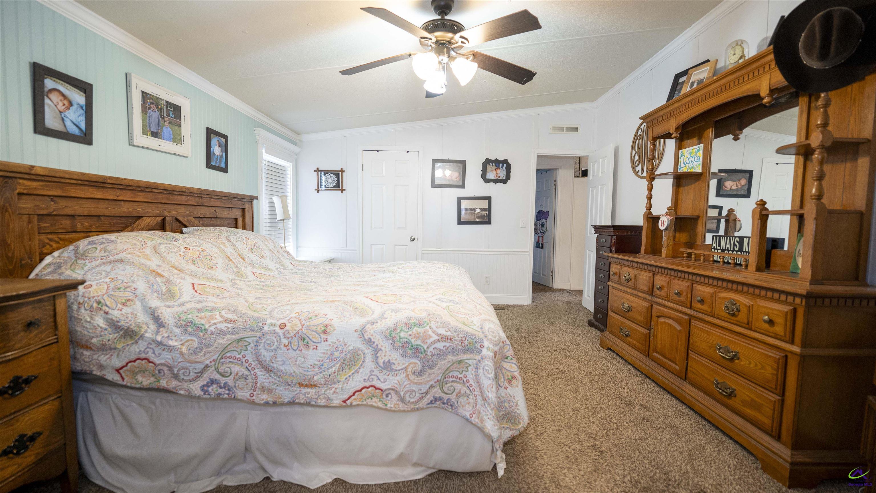 500 Old Milledgeville Road Cochran, GA 31014 - Photo 37 of 48 a spacious bedroom with a bed and cabinets