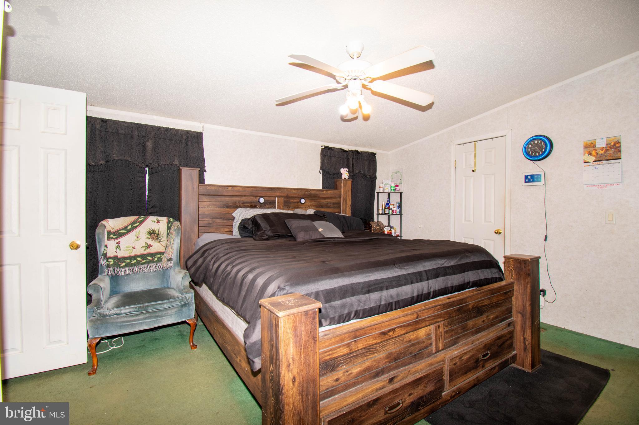 8791 Menokin Road Montross, VA 22520 - Photo 21 of 37 a bedroom with a bed and a chandelier