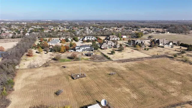an aerial view of a house with a beach