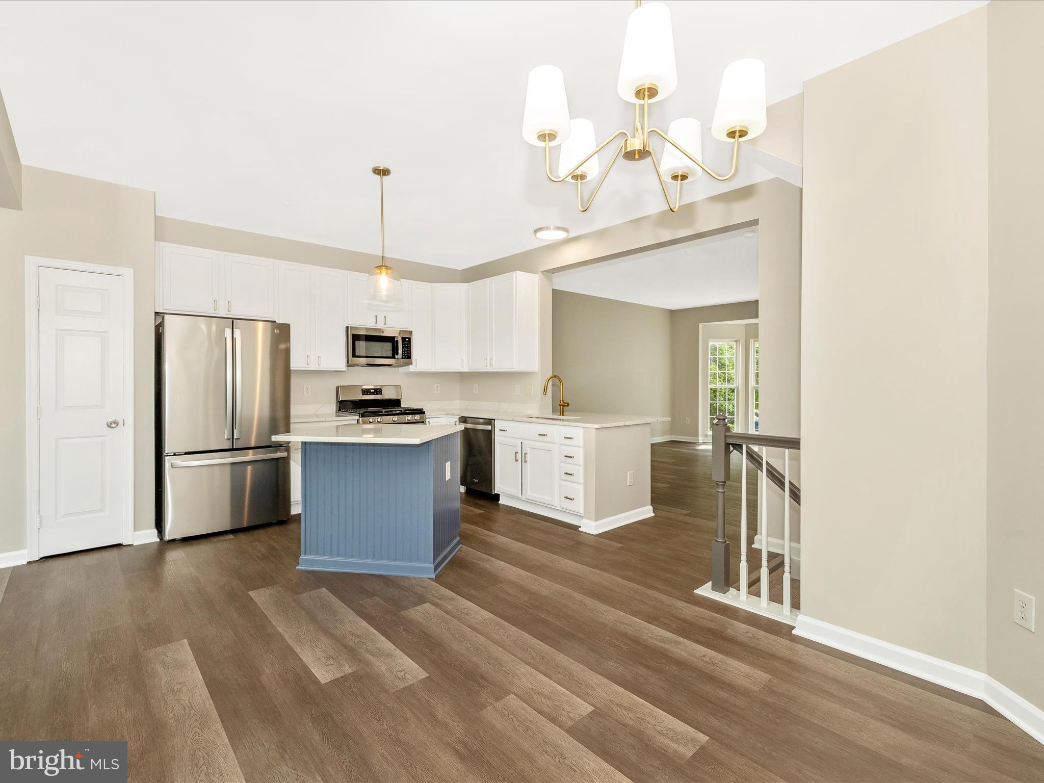 5534 Upshur Square Frederick, MD 21703 - Photo 11 of 46 a kitchen with kitchen island a sink stainless steel appliances and cabinets