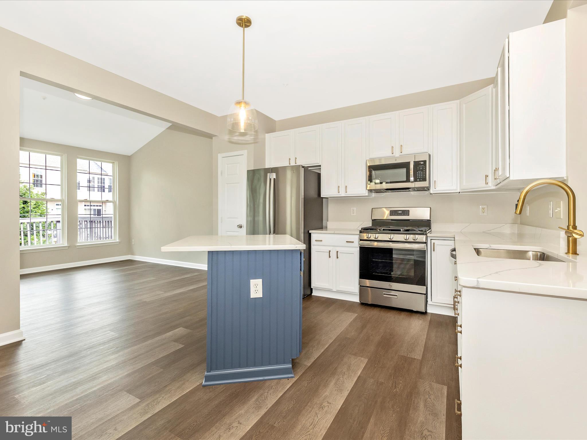 5534 Upshur Square Frederick, MD 21703 - Photo 12 of 46 a kitchen with stainless steel appliances granite countertop a stove a sink dishwasher a refrigerator and a oven with wooden floor
