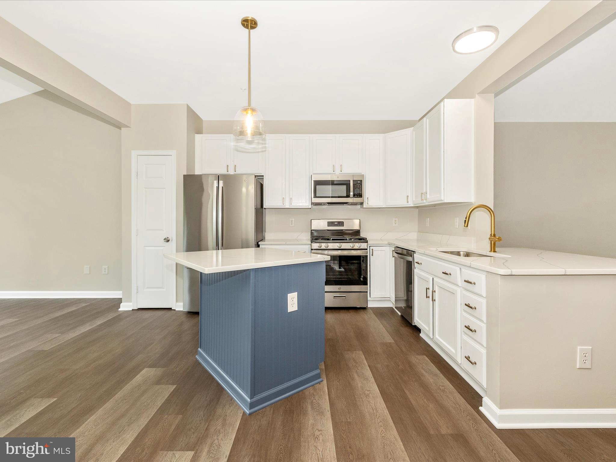 5534 Upshur Square Frederick, MD 21703 - Photo 13 of 46 a kitchen with stainless steel appliances a stove refrigerator sink and cabinets