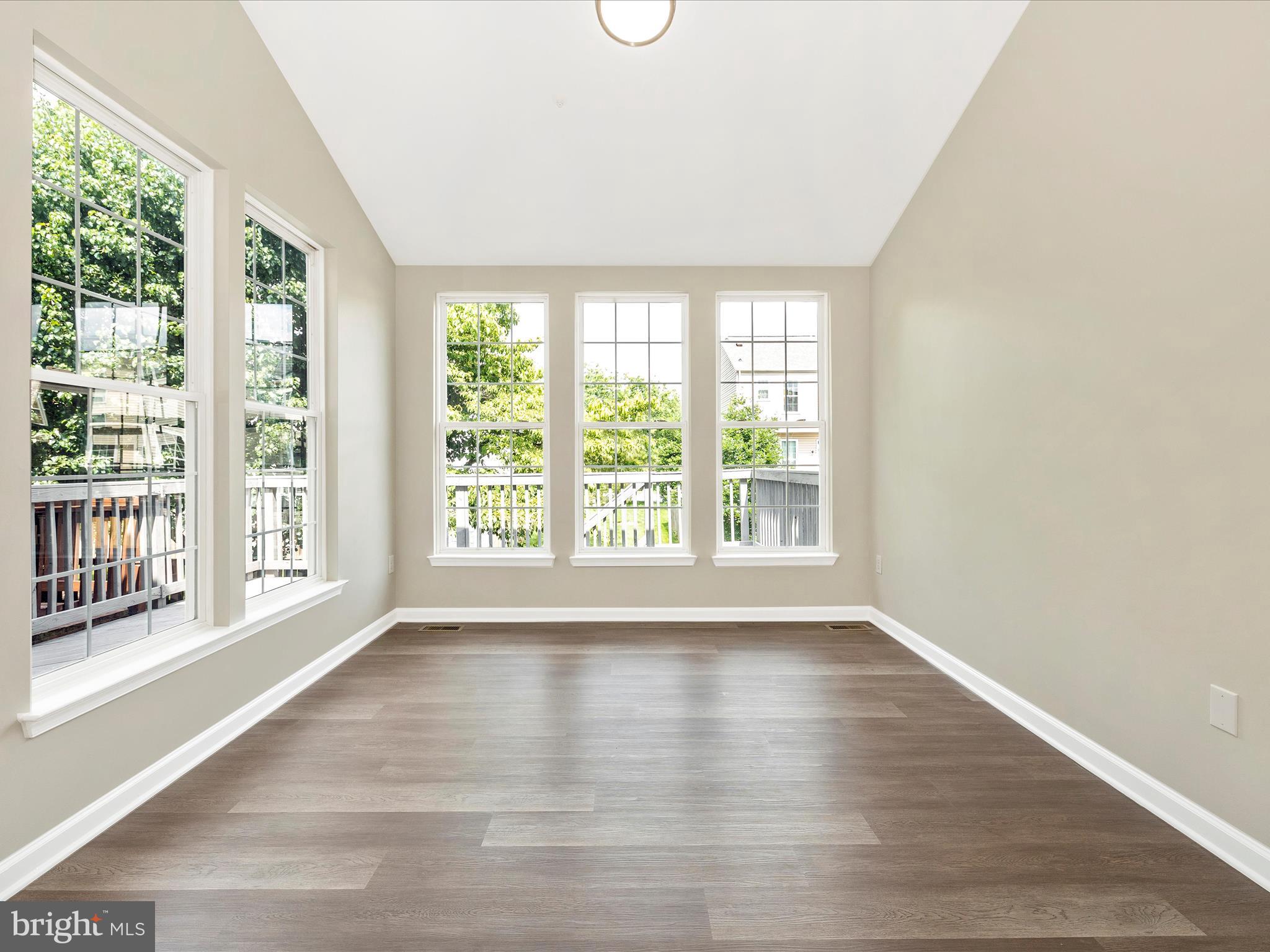 5534 Upshur Square Frederick, MD 21703 - Photo 18 of 46 a view of an empty room with wooden floor and a window
