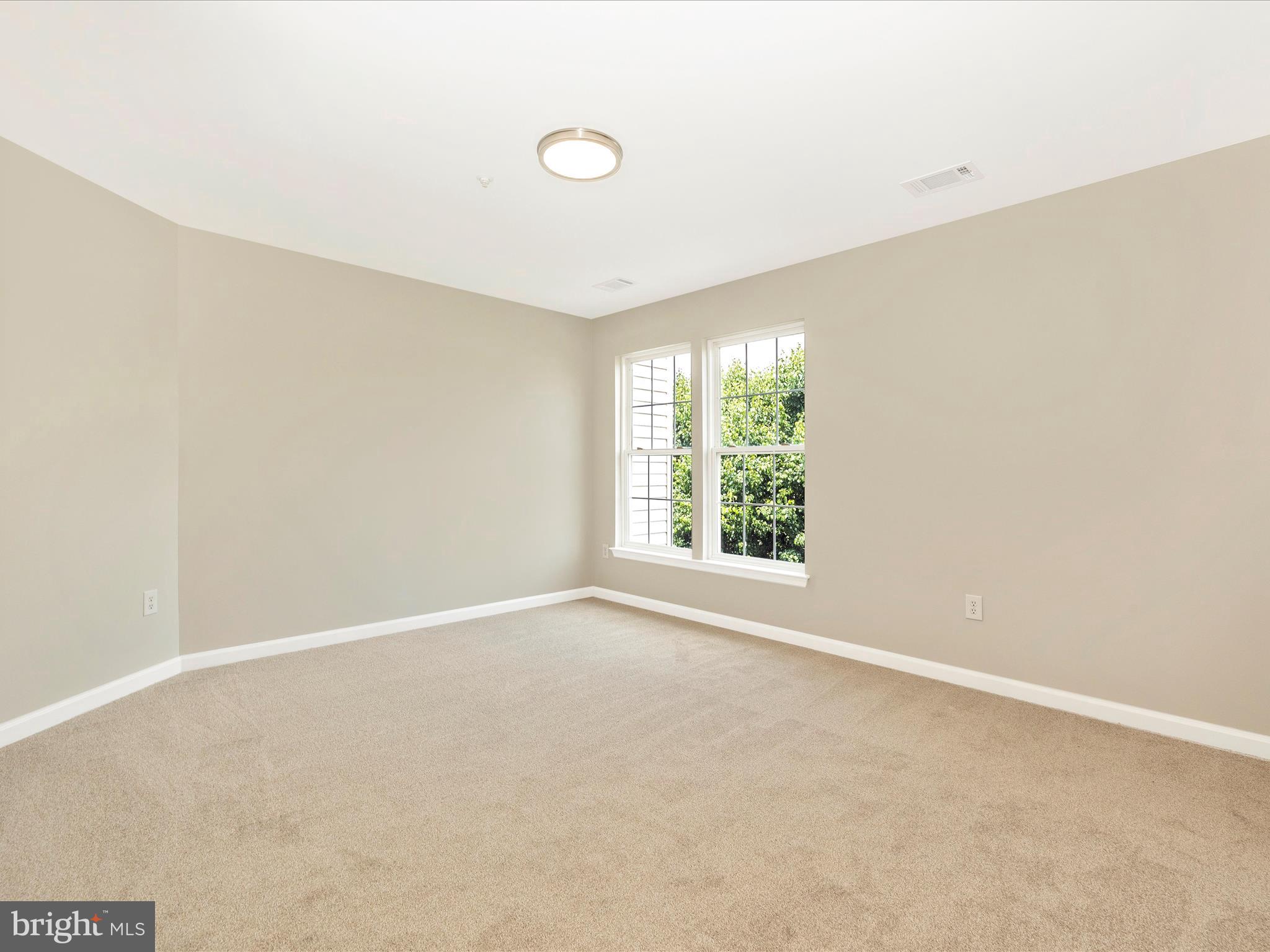 5534 Upshur Square Frederick, MD 21703 - Photo 22 of 46 an empty room with windows and closet