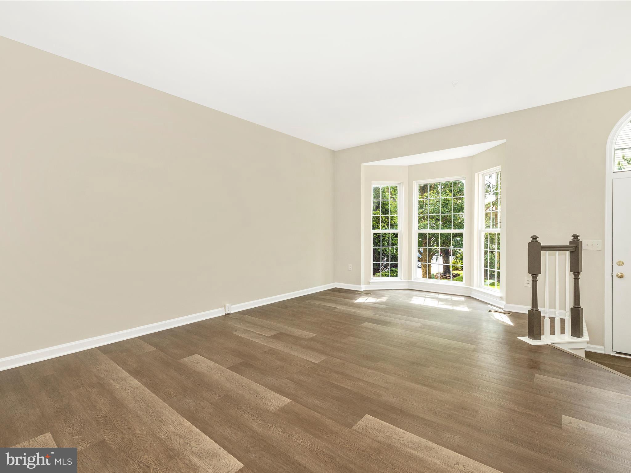 5534 Upshur Square Frederick, MD 21703 - Photo 6 of 46 an empty room with wooden floor and windows