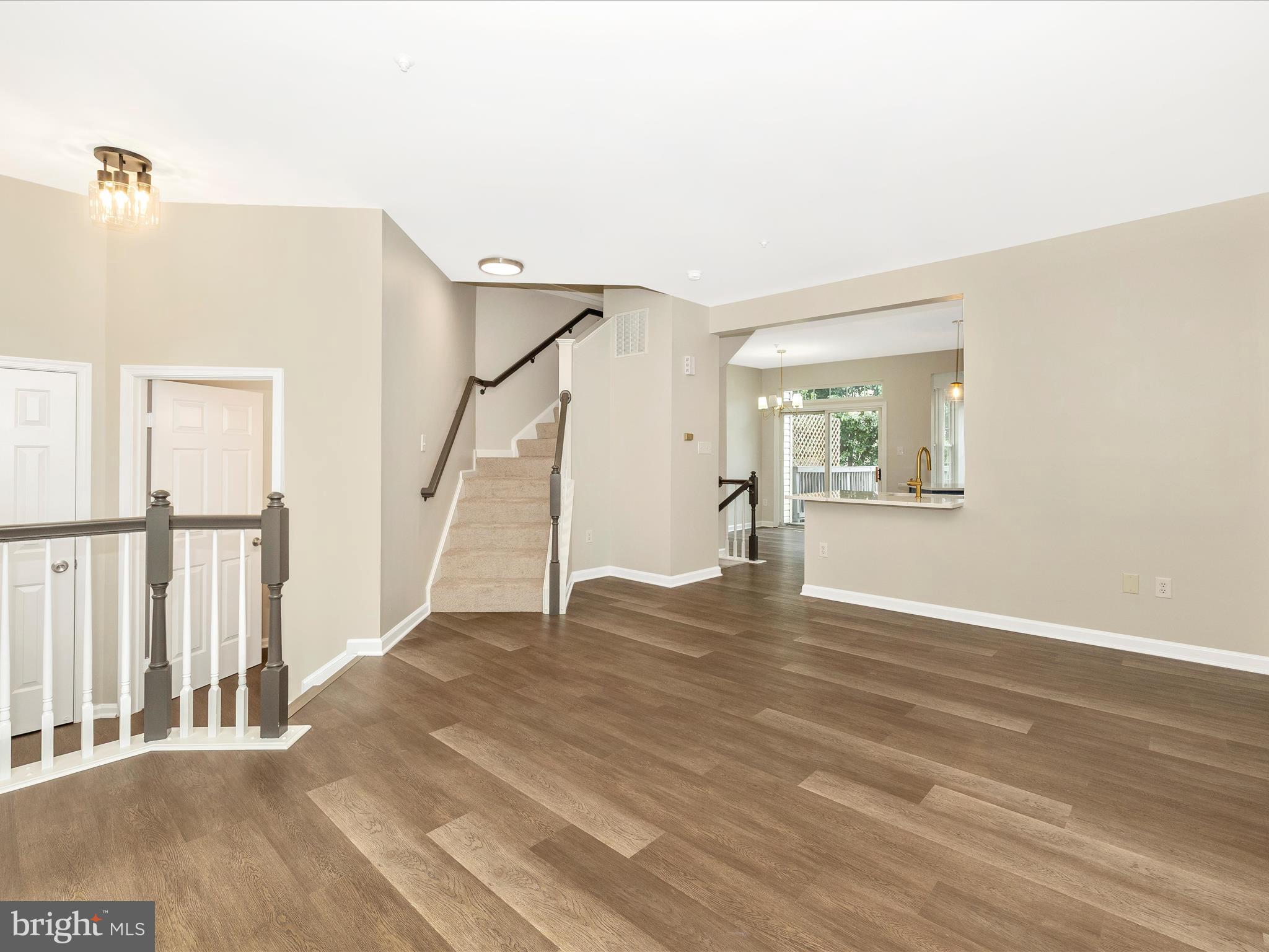 5534 Upshur Square Frederick, MD 21703 - Photo 8 of 46 a view of an empty room with wooden floor and a window