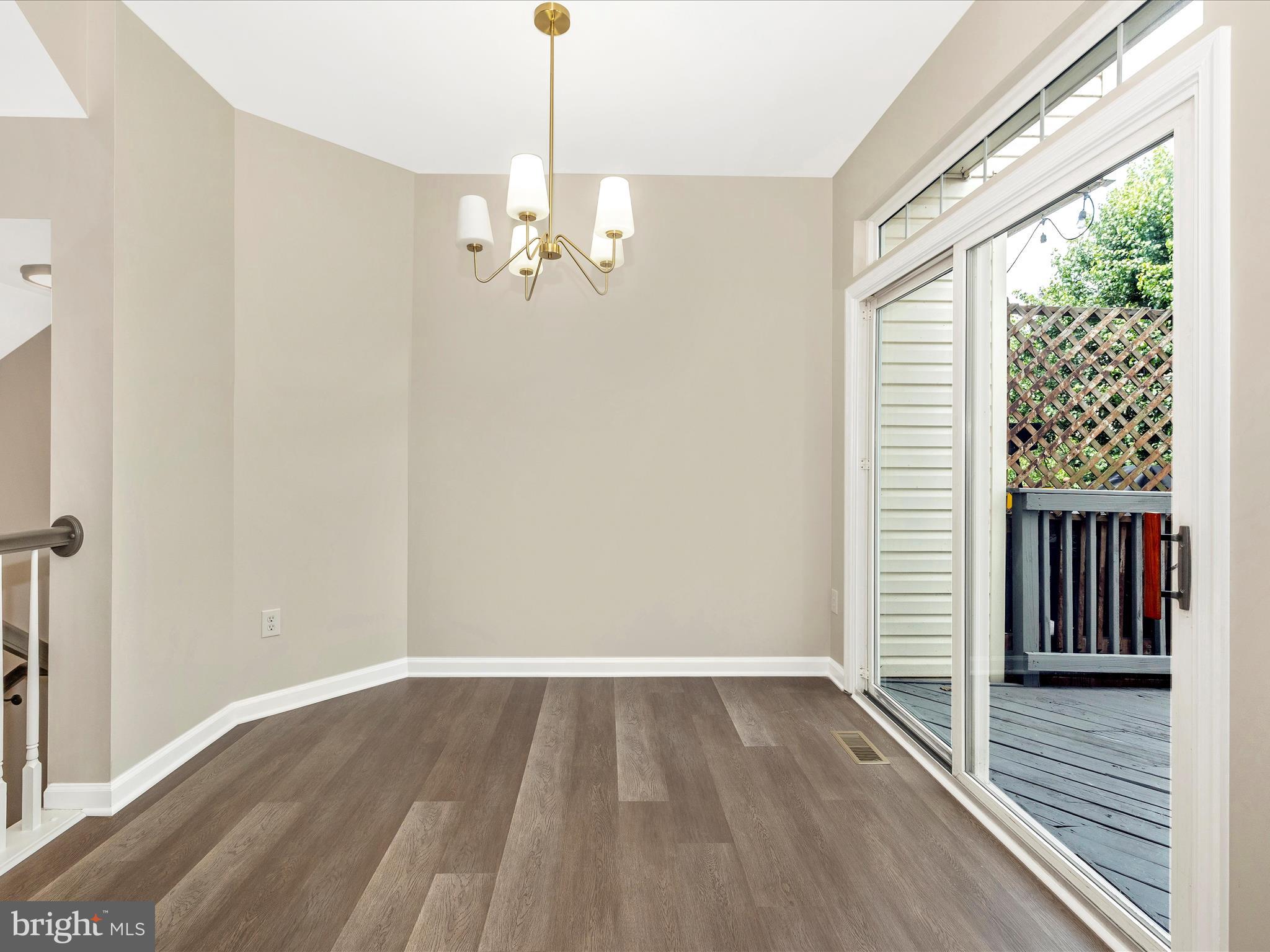 5534 Upshur Square Frederick, MD 21703 - Photo 10 of 46 a view of a room with wooden floor staircase and a ceiling fan