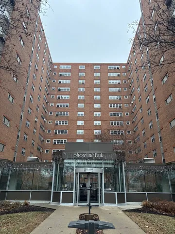 front view of a building with a tree