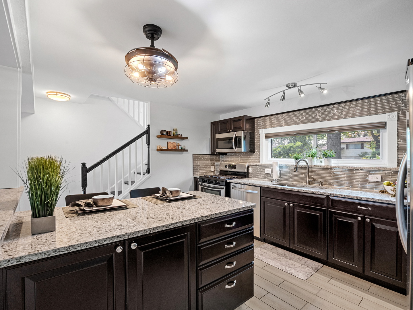 111 Timber Trail Streamwood, IL 60107 - Photo 12 of 35 a kitchen with stainless steel appliances granite countertop a sink and cabinets