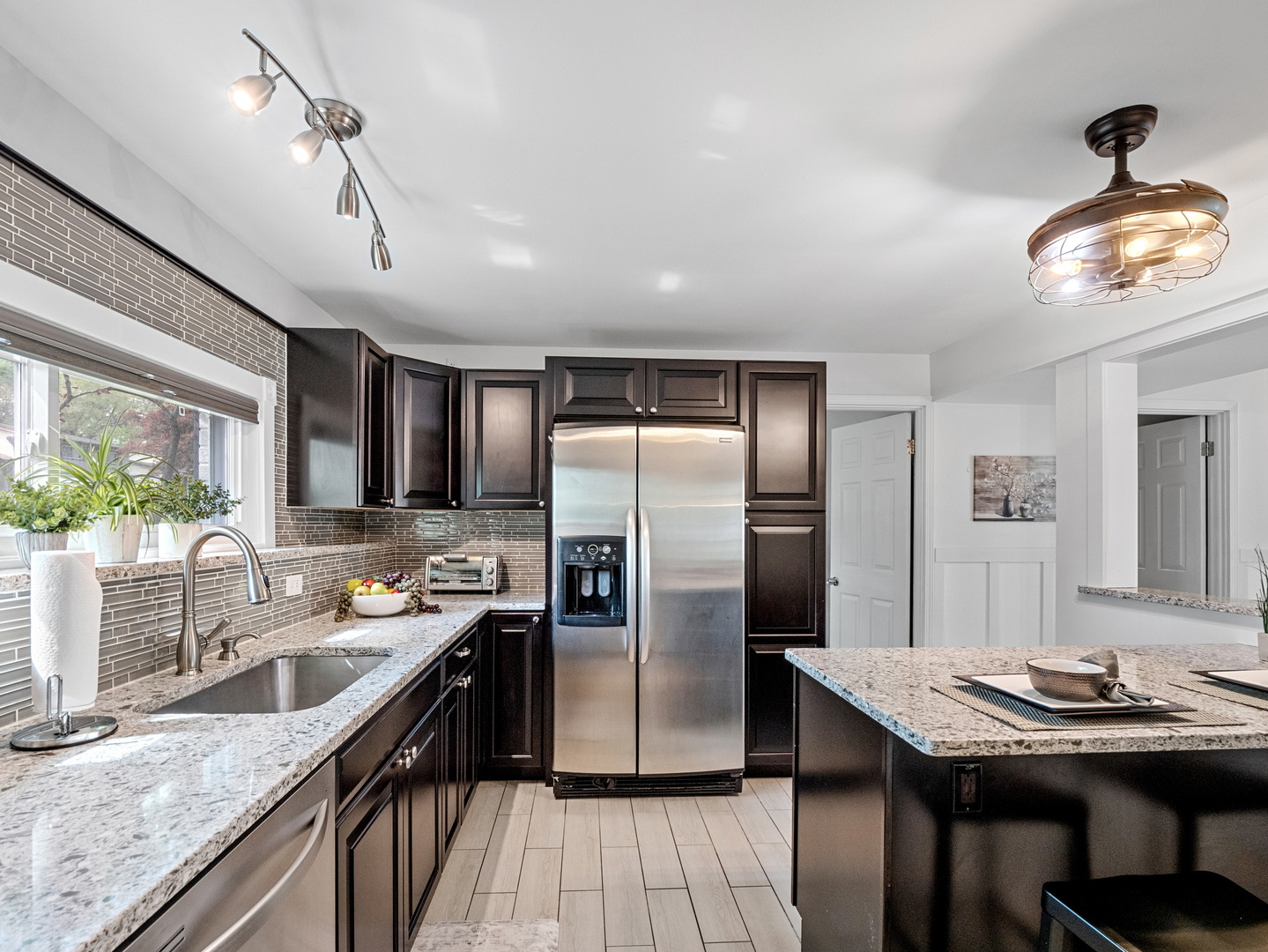 111 Timber Trail Streamwood, IL 60107 - Photo 13 of 35 a kitchen with stainless steel appliances granite countertop a sink refrigerator stove dining table and chairs