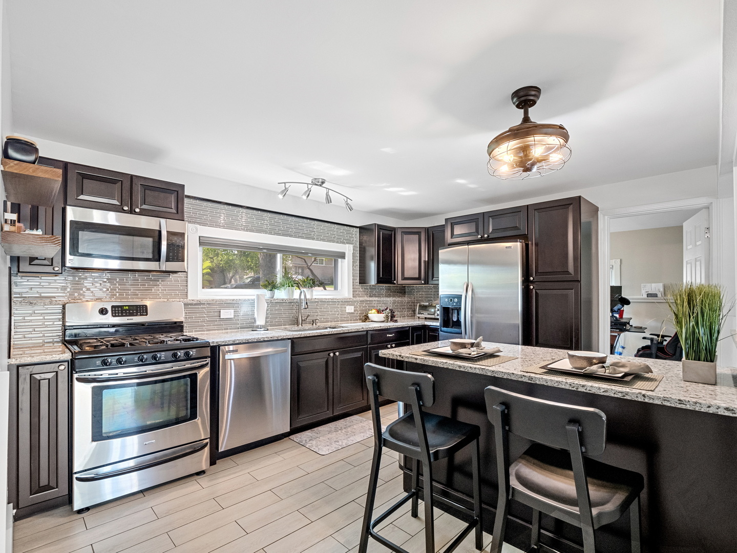 111 Timber Trail Streamwood, IL 60107 - Photo 14 of 35 a kitchen with stainless steel appliances a stove a sink and a refrigerator