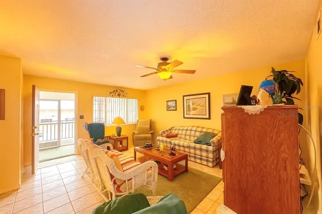 a view of a hallway with chairs and table in a livingroom