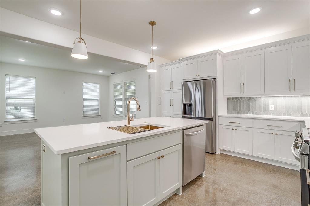 100 Cardinal Wds Granbury, TX 76049 - Photo 9 of 32 a kitchen with white cabinets and white appliances
