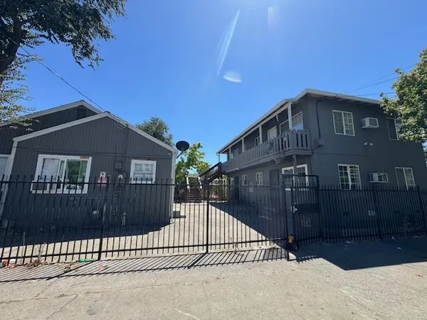 a view of a house with wooden fence