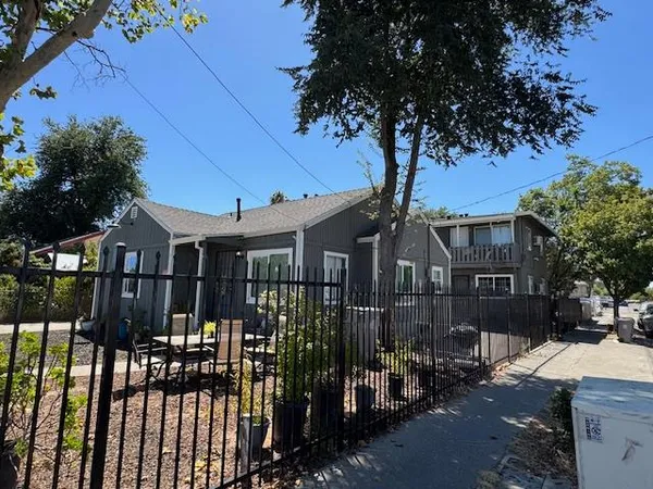 a front view of a house with parking area
