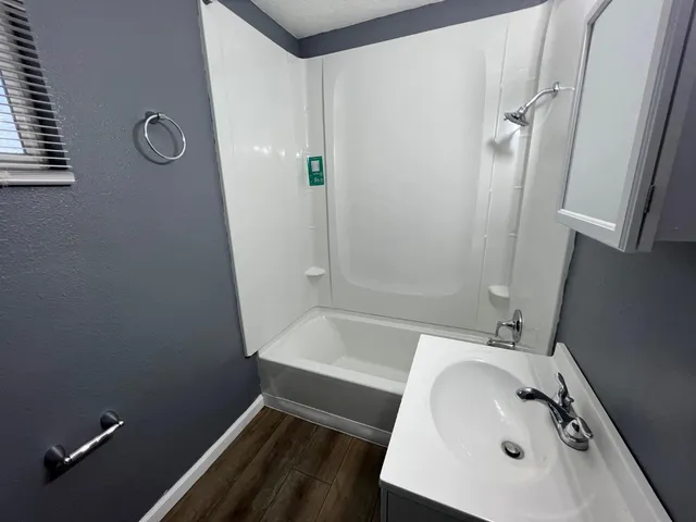 a bathroom with a sink and shower