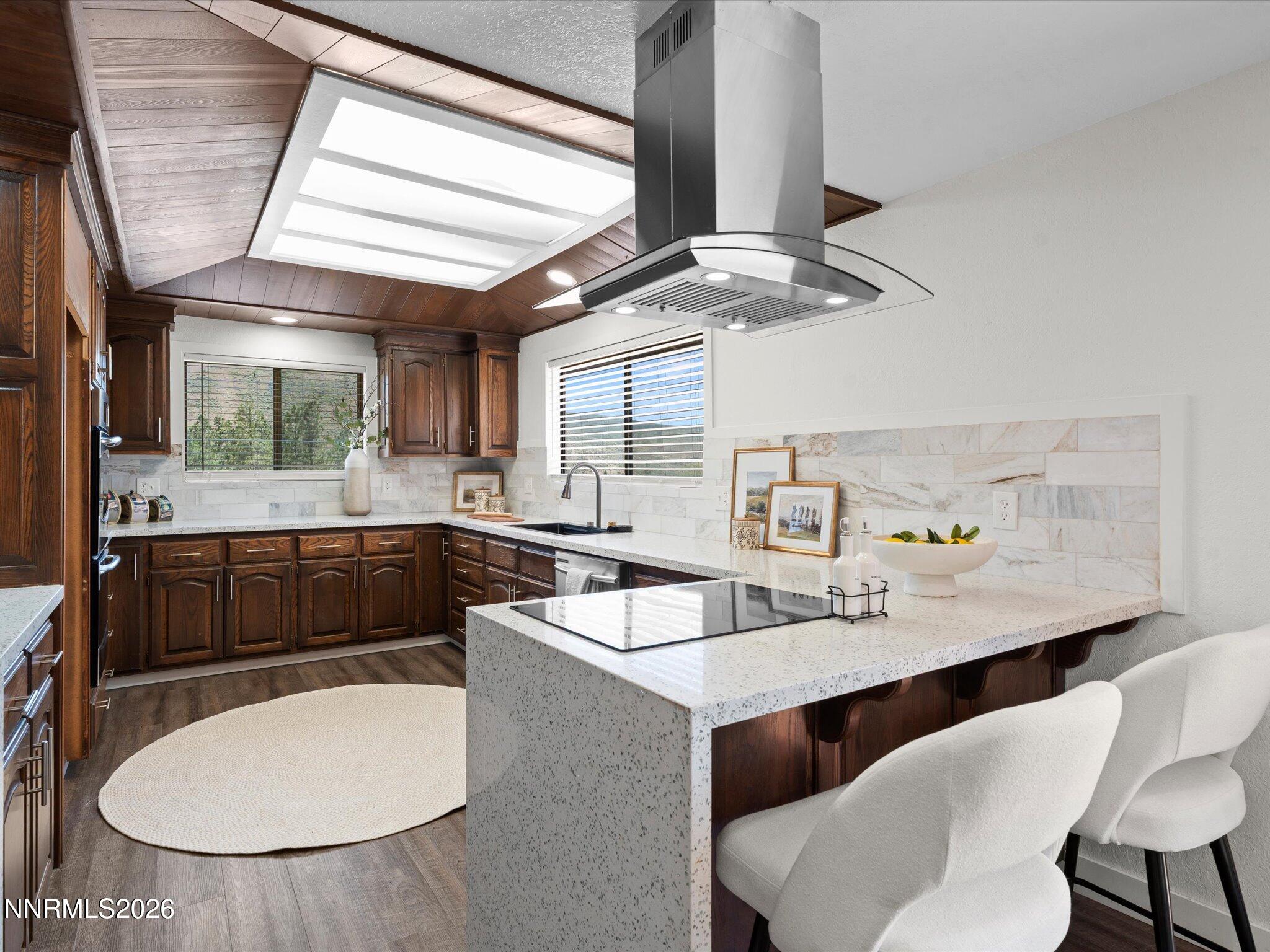 20449 Temelec Way Reno, NV 89521 - Photo 22 of 65 a kitchen with a table chairs sink and cabinets