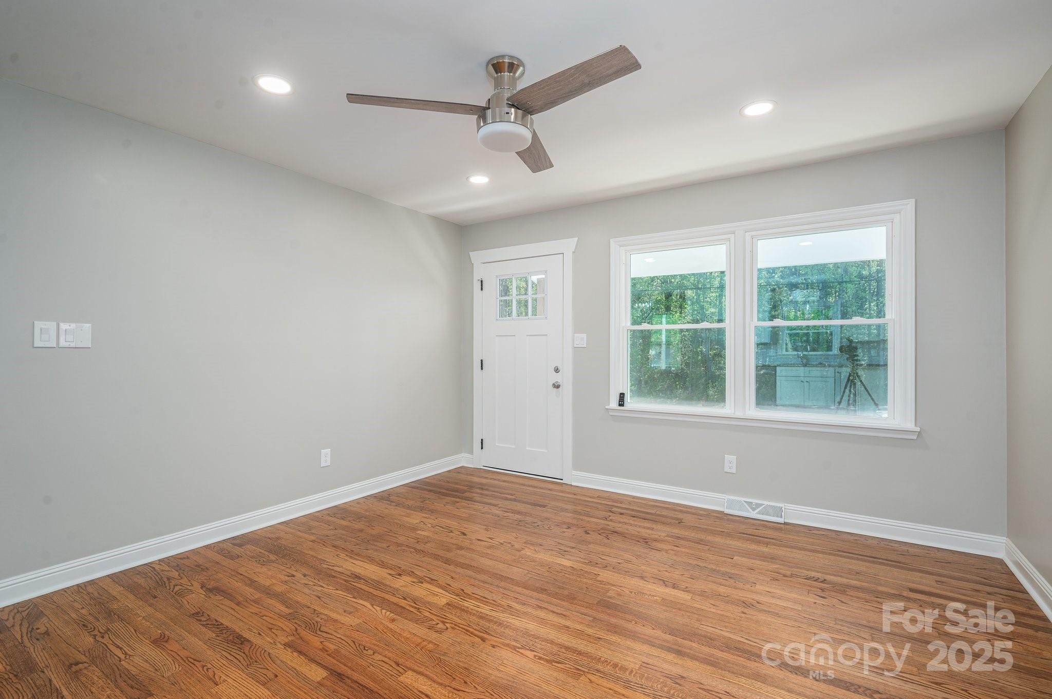 692 South Pink Street Cherryville, NC 28021 - Photo 13 of 35 an empty room with wooden floor and windows