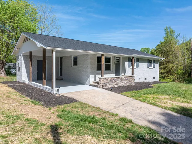 a front view of house with yard and outdoor seating