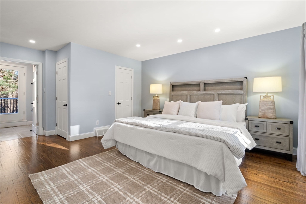 9 Mallard Drive Sharon, MA 02067 - Photo 14 of 32 a spacious bedroom with a bed and a wooden floor