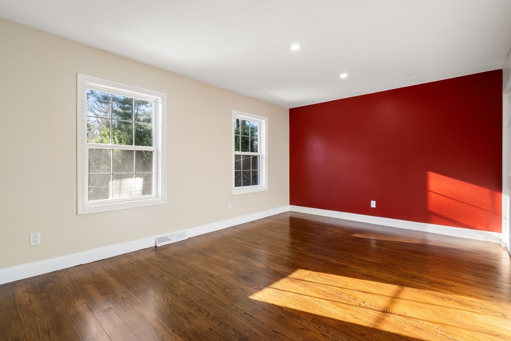 9 Mallard Drive Sharon, MA 02067 - Photo 20 of 32 a view of an empty room with wooden floor and a window