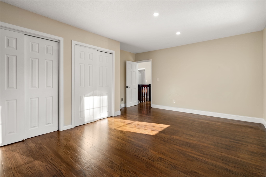 9 Mallard Drive Sharon, MA 02067 - Photo 21 of 32 a view of an empty room with wooden floor