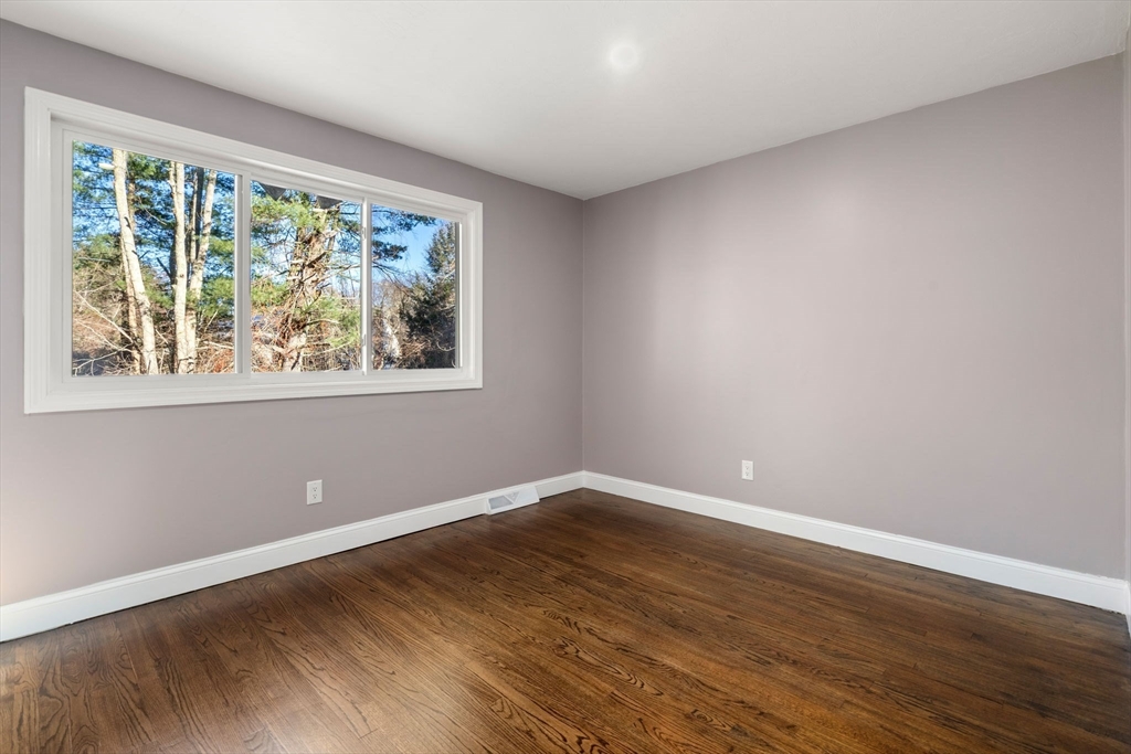 9 Mallard Drive Sharon, MA 02067 - Photo 22 of 32 a view of empty room with wooden floor and fan