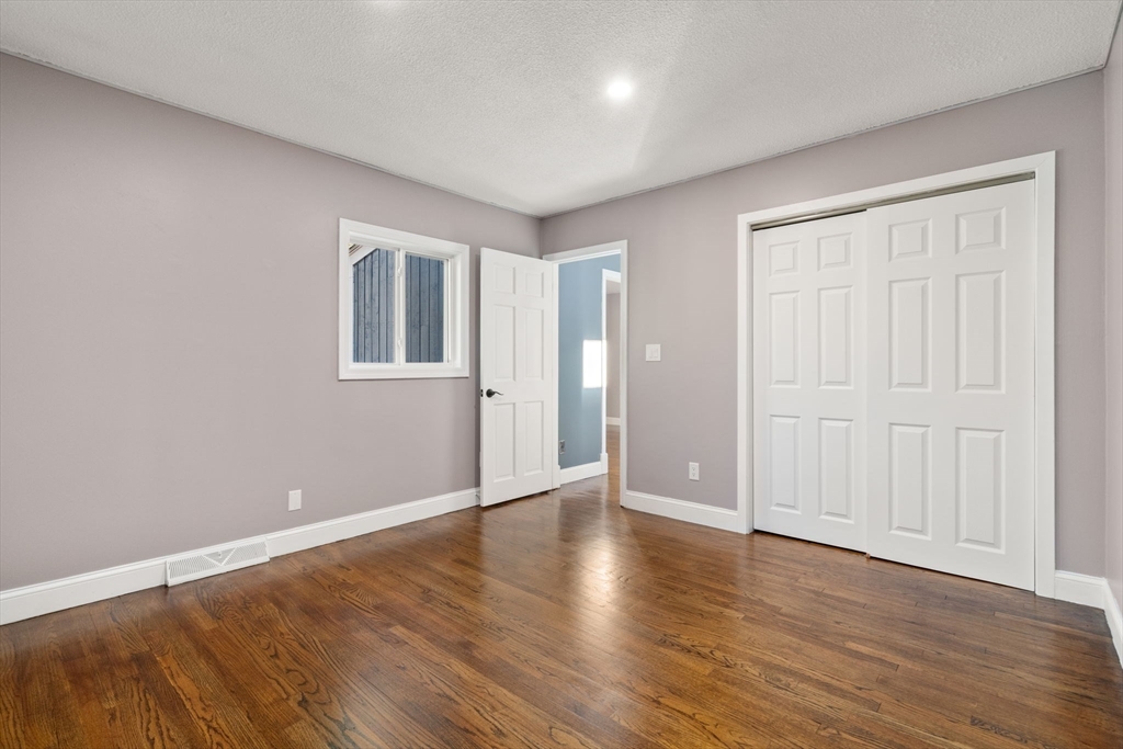 9 Mallard Drive Sharon, MA 02067 - Photo 23 of 32 a view of an empty room with wooden floor