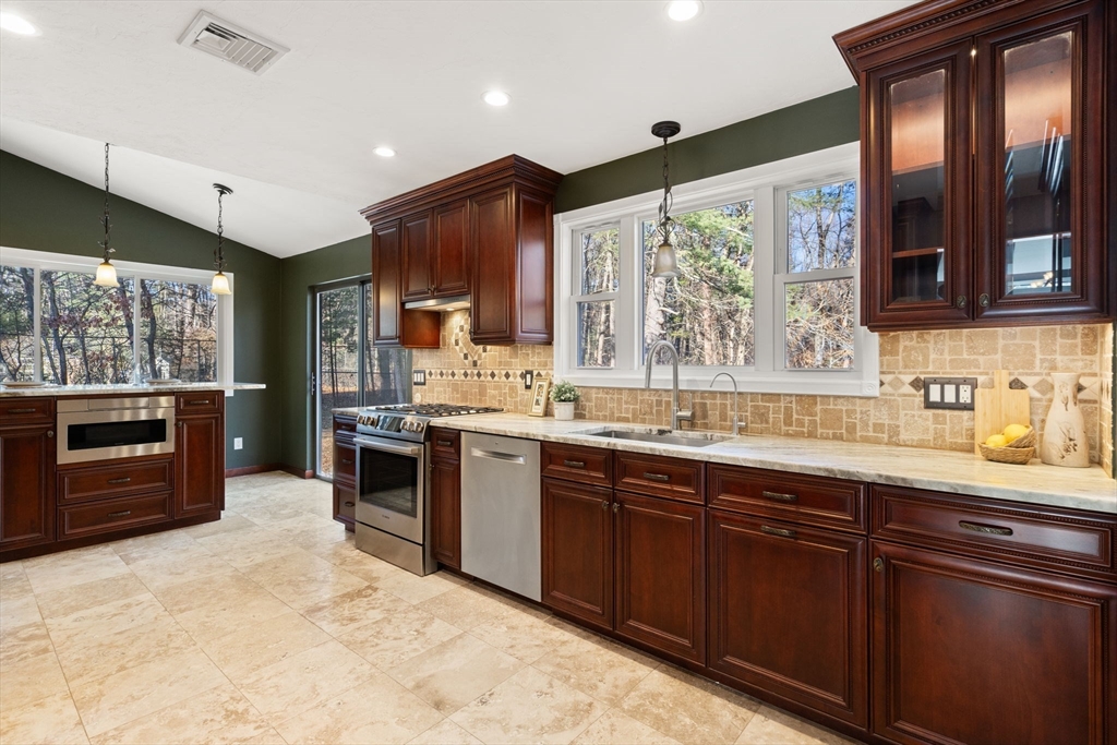 9 Mallard Drive Sharon, MA 02067 - Photo 6 of 32 a kitchen with stainless steel appliances granite countertop a sink stove and refrigerator